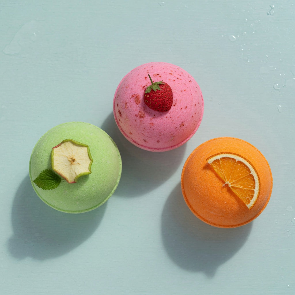 Three bath bombs: apple green, strawberry pink and orange